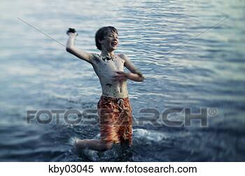 Stock Image - young boy throwing 
dirt clod from 
water. fotosearch 
- search stock 
photos, pictures, 
images, and photo 
clipart