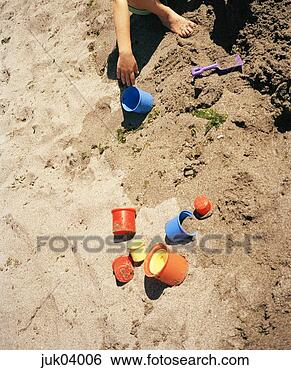 Stock Photo - young child playing 
in sand with toys. 
fotosearch - search 
stock photos, 
pictures, images, 
and photo clipart