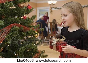 Stock Photo - young girl holding 
christmas present. 
fotosearch - search 
stock photos, 
pictures, images, 
and photo clipart