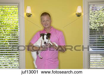 Stock Photography - young man holding 
his dog. fotosearch 
- search stock 
photos, pictures, 
images, and photo 
clipart