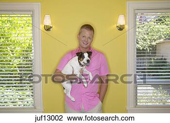 Stock Photo - young man holding 
his dog. fotosearch 
- search stock 
photos, pictures, 
images, and photo 
clipart