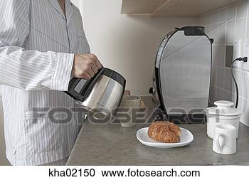 Stock Photography - young man making 
breakfast. fotosearch 
- search stock 
photos, pictures, 
images, and photo 
clipart