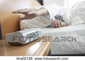 Stock Photo - young man reaching 
for alarm clock. 
fotosearch - search 
stock photos, 
pictures, images, 
and photo clipart