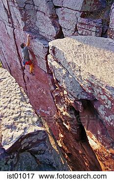 Picture - young man rock 
climbing. fotosearch 
- search stock 
photos, pictures, 
images, and photo 
clipart