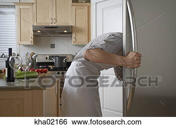 Stock Photo - young man searching 
in fridge. fotosearch 
- search stock 
photos, pictures, 
images, and photo 
clipart
