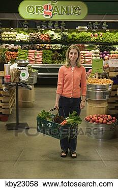 Stock Photo - young woman shopping 
in organic produce 
aisle in grocery 
store. fotosearch 
- search stock 
photos, pictures, 
images, and photo 
clipart