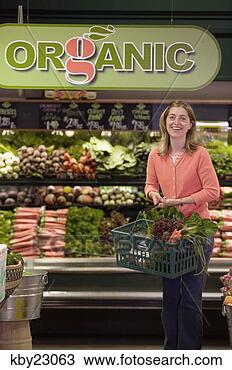Stock Photo - young woman shopping 
in organic produce 
aisle of grocery 
store. fotosearch 
- search stock 
photos, pictures, 
images, and photo 
clipart