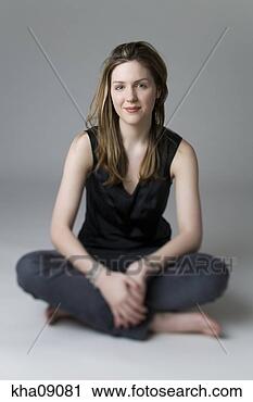 Stock Photography - young woman sitting 
cross-legged. 
fotosearch - search 
stock photos, 
pictures, images, 
and photo clipart
