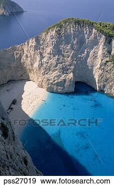 Stock Photograph - aerial view of 
boat in cove on 
rugged coastline. 
fotosearch - search 
stock photos, 
pictures, images, 
and photo clipart