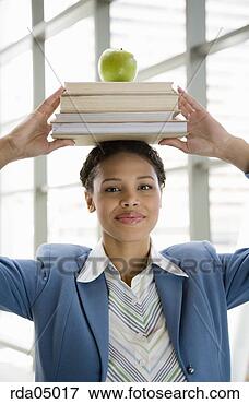 Picture - african businesswoman 
with books on 
head. fotosearch 
- search stock 
photos, pictures, 
images, and photo 
clipart
