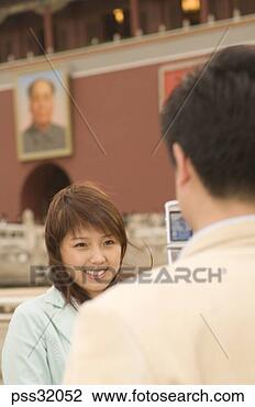 Stock Photo - asian man taking 
photograph of 
asian woman with 
cell phone. fotosearch 
- search stock 
photos, pictures, 
images, and photo 
clipart