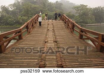 Stock Photograph - asian people walking 
on wooden footbridge 
over water. fotosearch 
- search stock 
photos, pictures, 
images, and photo 
clipart