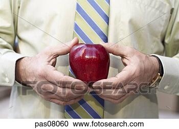 Stock Photography - businessman holding 
apple. fotosearch 
- search stock 
photos, pictures, 
images, and photo 
clipart