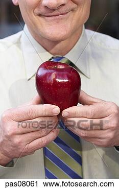 Stock Photography - businessman holding 
apple. fotosearch 
- search stock 
photos, pictures, 
images, and photo 
clipart