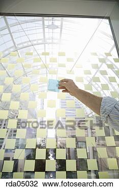 Stock Photo - businessman holding 
sticky note. fotosearch 
- search stock 
photos, pictures, 
images, and photo 
clipart