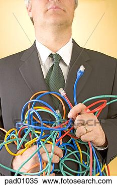Stock Image - businessman holding 
tangled wires. 
fotosearch - search 
stock photos, 
pictures, images, 
and photo clipart
