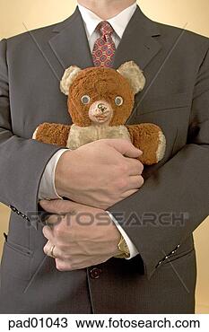 Stock Photo - businessman hugging 
teddy bear. fotosearch 
- search stock 
photos, pictures, 
images, and photo 
clipart