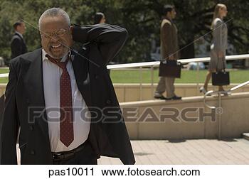 Stock Photography - businessman rubbing 
his neck. fotosearch 
- search stock 
photos, pictures, 
images, and photo 
clipart
