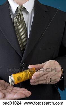 Stock Photo - businessman shaking 
money out of prescription 
bottle. fotosearch 
- search stock 
photos, pictures, 
images, and photo 
clipart