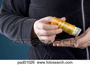 Stock Photo - businessman shaking 
money out of prescription 
bottle. fotosearch 
- search stock 
photos, pictures, 
images, and photo 
clipart