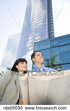 Stock Photography - businesspeople 
holding blueprints. 
fotosearch - search 
stock photos, 
pictures, images, 
and photo clipart
