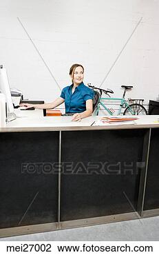 Stock Photo - businesswoman 
sitting at desk. 
fotosearch - search 
stock photos, 
pictures, images, 
and photo clipart