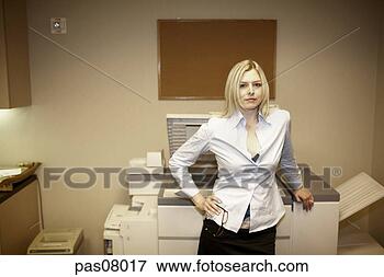Picture - businesswoman 
standing by copy 
machine. fotosearch 
- search stock 
photos, pictures, 
images, and photo 
clipart