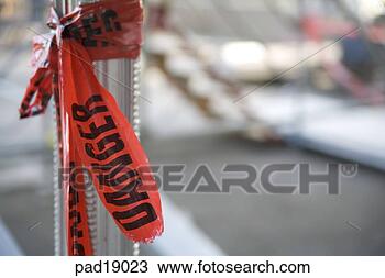 Stock Photo - close-up of danger 
tape tied up on 
pole. fotosearch 
- search stock 
photos, pictures, 
images, and photo 
clipart