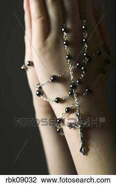 Stock Photo - close-up of rosary 
beads and hands. 
fotosearch - search 
stock photos, 
pictures, images, 
and photo clipart