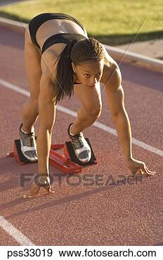Stock Photograph - close-up of young 
adult woman at 
starting block. 
fotosearch - search 
stock photos, 
pictures, images, 
and photo clipart