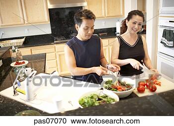 Stock Photography - couple cooking 
in kitchen. fotosearch 
- search stock 
photos, pictures, 
images, and photo 
clipart