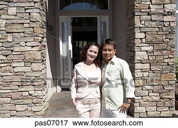 Picture - couple standing 
outside their 
house. fotosearch 
- search stock 
photos, pictures, 
images, and photo 
clipart