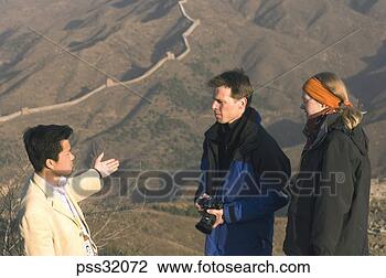 Stock Photo - couple with tour 
guide showing 
great wall of 
china. fotosearch 
- search stock 
photos, pictures, 
images, and photo 
clipart