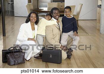 Stock Photo - family kneeling 
in livingroom. 
fotosearch - search 
stock photos, 
pictures, images, 
and photo clipart