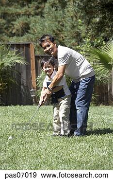 Stock Photograph - father teaching 
his son to play 
golf. fotosearch 
- search stock 
photos, pictures, 
images, and photo 
clipart