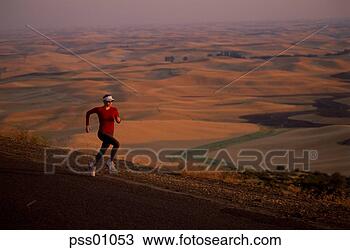 Stock Photo - female athlete 
running on rural 
road. fotosearch 
- search stock 
photos, pictures, 
images, and photo 
clipart