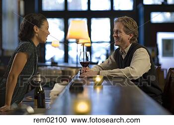 Stock Photography - female bartender 
with customer 
at bar. fotosearch 
- search stock 
photos, pictures, 
images, and photo 
clipart