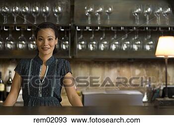 Stock Photo - female bartender 
standing at bar 
counter. fotosearch 
- search stock 
photos, pictures, 
images, and photo 
clipart
