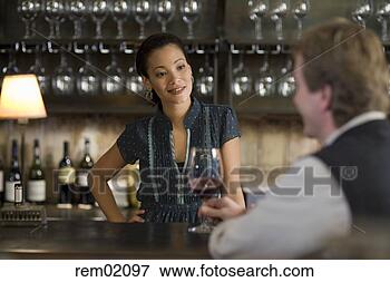 Picture - female bartender 
talking to customer. 
fotosearch - search 
stock photos, 
pictures, images, 
and photo clipart