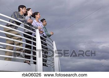 Stock Photo - four business 
people leaning 
on balcony. fotosearch 
- search stock 
photos, pictures, 
images, and photo 
clipart