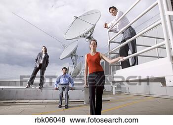 Stock Photo - four people on 
roof near satellite 
dishes. fotosearch 
- search stock 
photos, pictures, 
images, and photo 
clipart