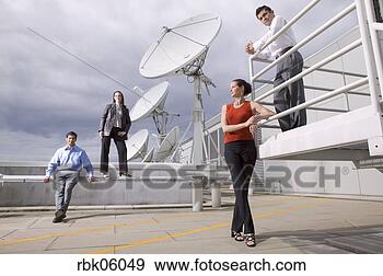Stock Photograph - four people on 
roof near satellite 
dishes. fotosearch 
- search stock 
photos, pictures, 
images, and photo 
clipart