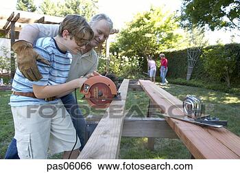 Stock Photo - grandfather and 
grandson using 
a saw. fotosearch 
- search stock 
photos, pictures, 
images, and photo 
clipart