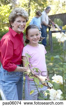 Stock Photo - grandmother and 
granddaughter 
smiling in backyard. 
fotosearch - search 
stock photos, 
pictures, images, 
and photo clipart