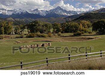 Stock Photograph - hayrolls in countryside, 
rocky mountains. 
fotosearch - search 
stock photos, 
pictures, images, 
and photo clipart