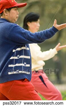 Picture - low angle view 
of senior asian 
adults practicing 
tai chi outdoors. 
fotosearch - search 
stock photos, 
pictures, images, 
and photo clipart