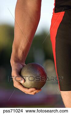 Stock Photo - male athlete holding 
shot put. fotosearch 
- search stock 
photos, pictures, 
images, and photo 
clipart