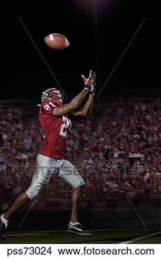Stock Photo - male football 
player catching 
football. fotosearch 
- search stock 
photos, pictures, 
images, and photo 
clipart