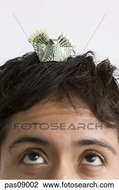 Stock Photo - man balancing 
dollar bill origami 
on head. fotosearch 
- search stock 
photos, pictures, 
images, and photo 
clipart