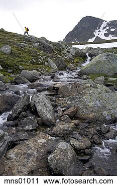 Stock Photography - man climbing up 
hill beside stream. 
fotosearch - search 
stock photos, 
pictures, images, 
and photo clipart